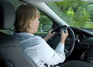 Woman driving and texting