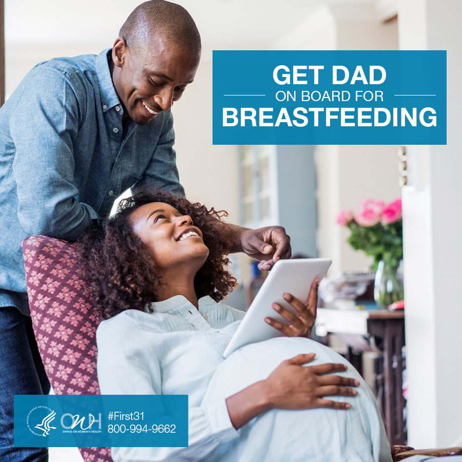 A father supports a mother seated in a cozy chair, holding a tablet, promoting the importance of dad's involvement in breastfeeding.